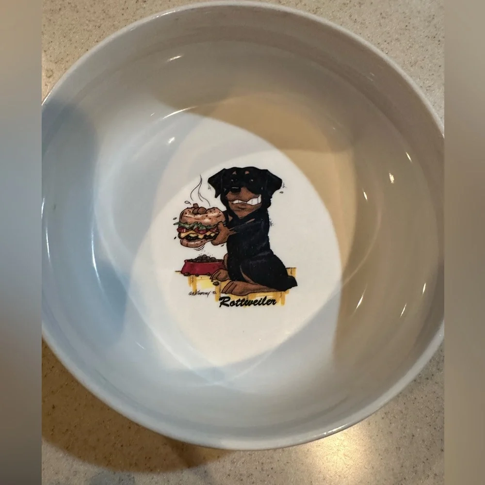 Rosalinde white dog bowl with Rottweiler and paw prints decor. Good shape.